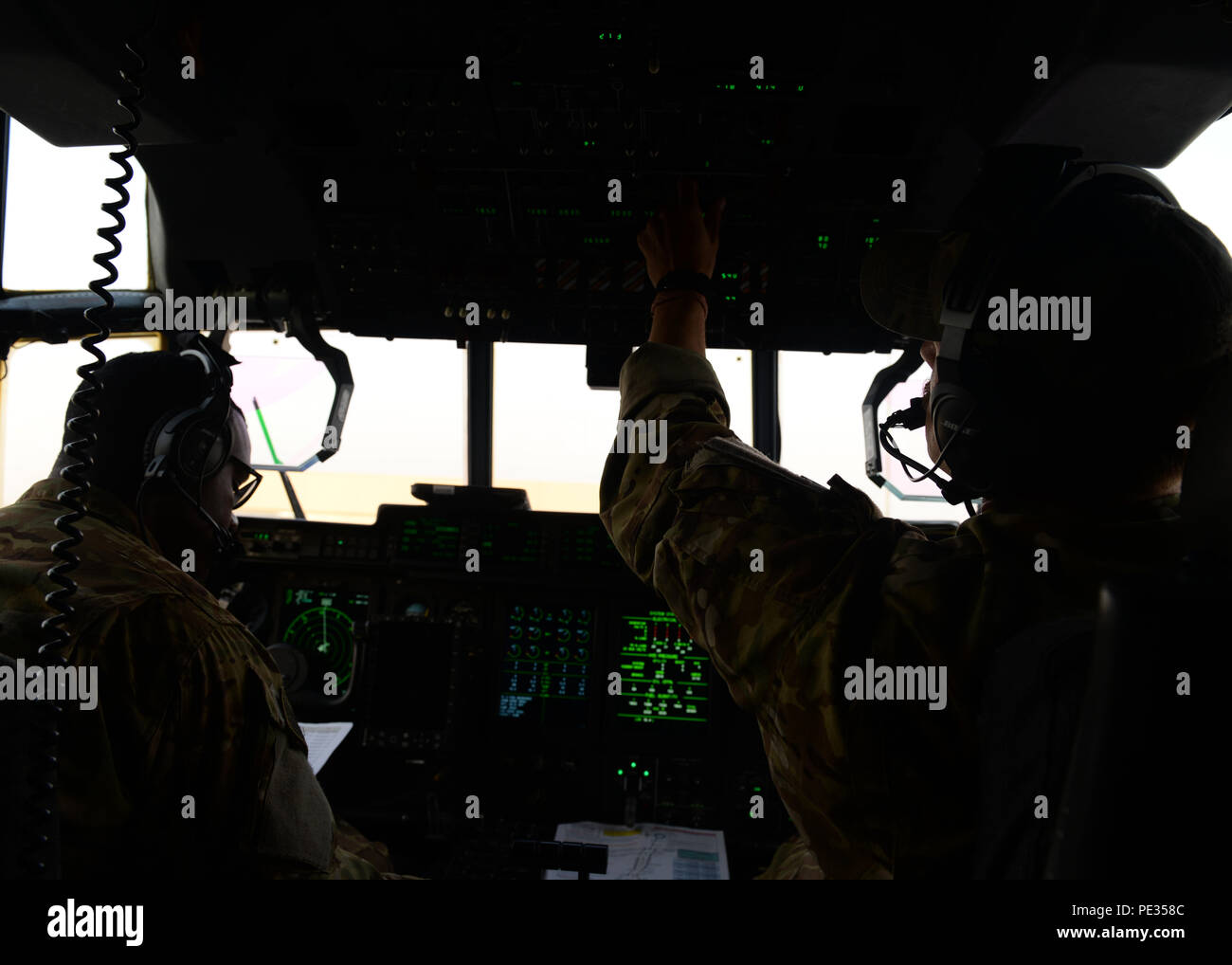 U.S. Air Force Capts. Boston McClain and Matt Buchholtz, 774th Expeditionary Airlift Squadron C-130J Super Hercules pilots, power on their aircraft in preparation for take-off from Al Udeid Air Base, Qatar, Sept. 3, 2015. The pilots, who are deployed from Little Rock Air Force Base, Ark., fly various combat missions throughout Afghanistan supporting missions ranging from medical evacuations to cargo and passenger transports. (U.S. Air Force photo by Senior Airman Cierra Presentado/Released) Stock Photo