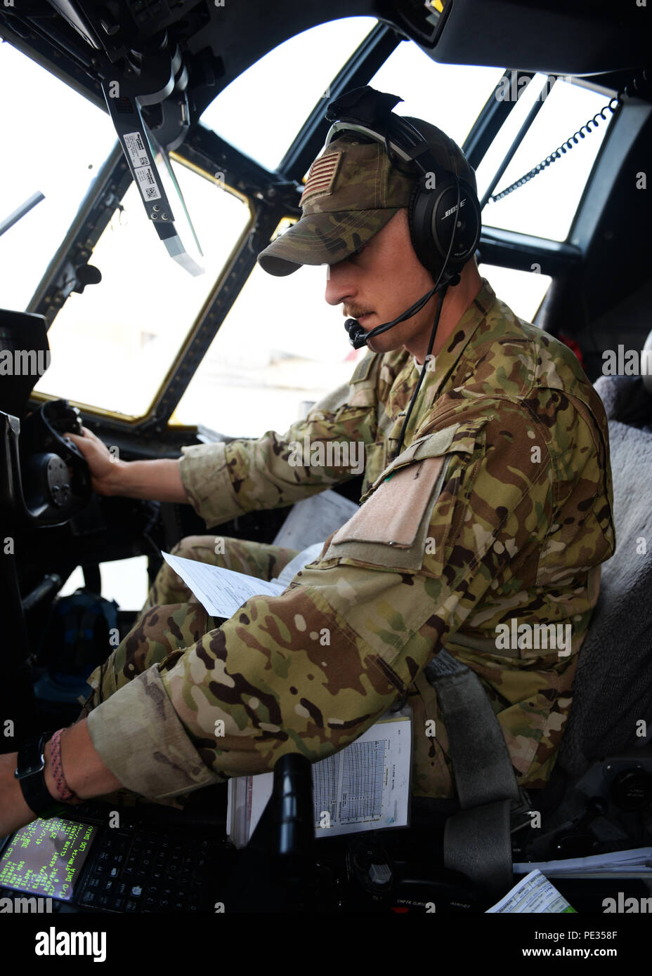 U.S. Air Force Capt. Matt Buchholtz, 774th Expeditionary Airlift Squadron C-130J Super Hercules pilot, turns on controls in preparation for take-off Sept. 3, 2015, at Al Udeid Air Base, Qatar. Buchholtz and his team, who are deployed from Little Rock Air Force Base, Ark., fly various combat missions throughout Afghanistan supporting missions ranging from medical evacuations to cargo and passenger transports. (U.S. Air Force photo by Senior Airman Cierra Presentado/Released) Stock Photo