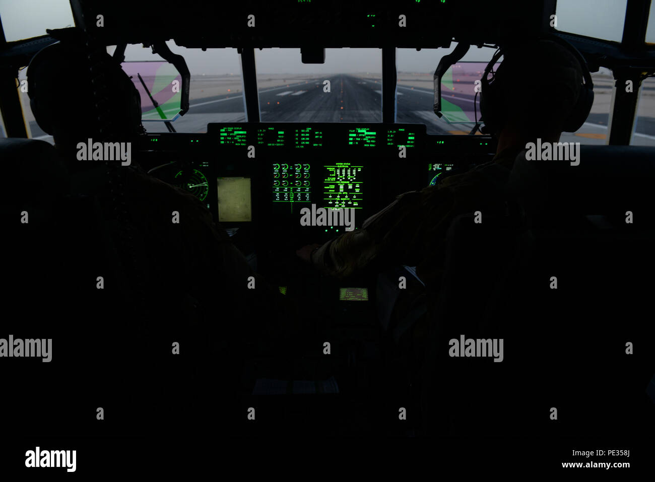 U.S. Air Force Capts. Boston McClain and Matt Buchholtz, 774th Expeditionary Airlift Squadron C-130J Super Hercules pilots, take-off for Bagram Air Field, Afghanistan, Sept. 3 2015, at Al Udeid Air Base, Qatar. The pilots, who are deployed from Little Rock Air Force Base, Ark., fly various combat missions throughout Afghanistan supporting missions ranging from medical evacuations to cargo and passenger transports. (U.S. Air Force photo by Senior Airman Cierra Presentado/Released) Stock Photo