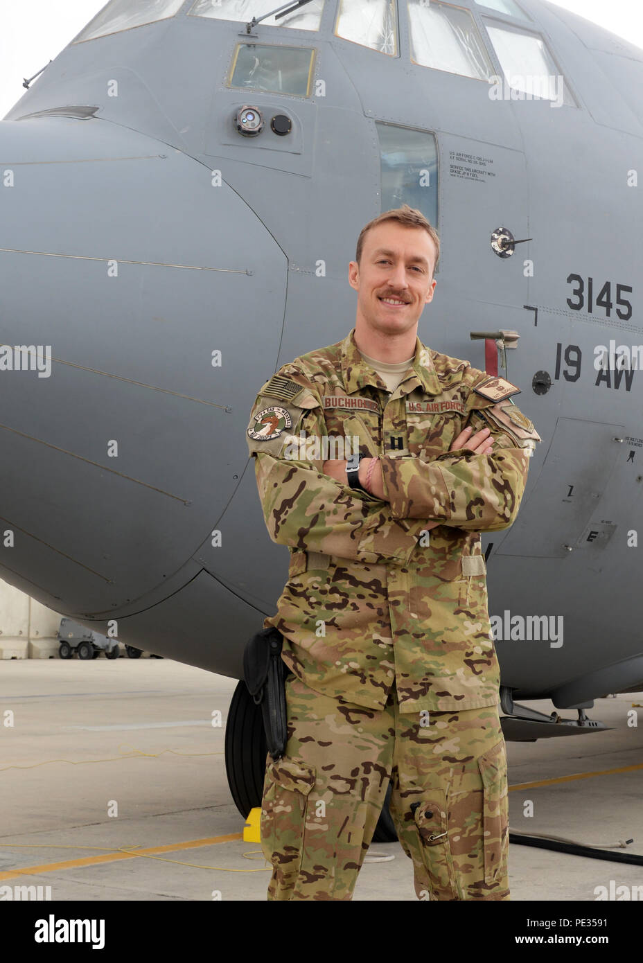 U.S. Air Force Capt. Matt Buchholtz, 774th Expeditionary Airlift Squadron C-130J Super Hercules pilot, poses for a photo in front of an aircraft Sept. 4, 2015, at Bagram Air Field, Afghanistan. Buchholtz is responsible for transporting mission essential assets as well as passengers to various forward operating bases throughout Afghanistan. (U.S. Air Force photo by Senior Airman Cierra Presentado/Released) Stock Photo