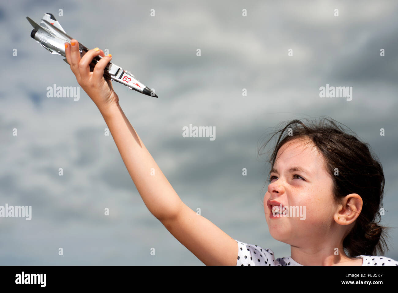 Young girl playing with a model aircraft Stock Photo