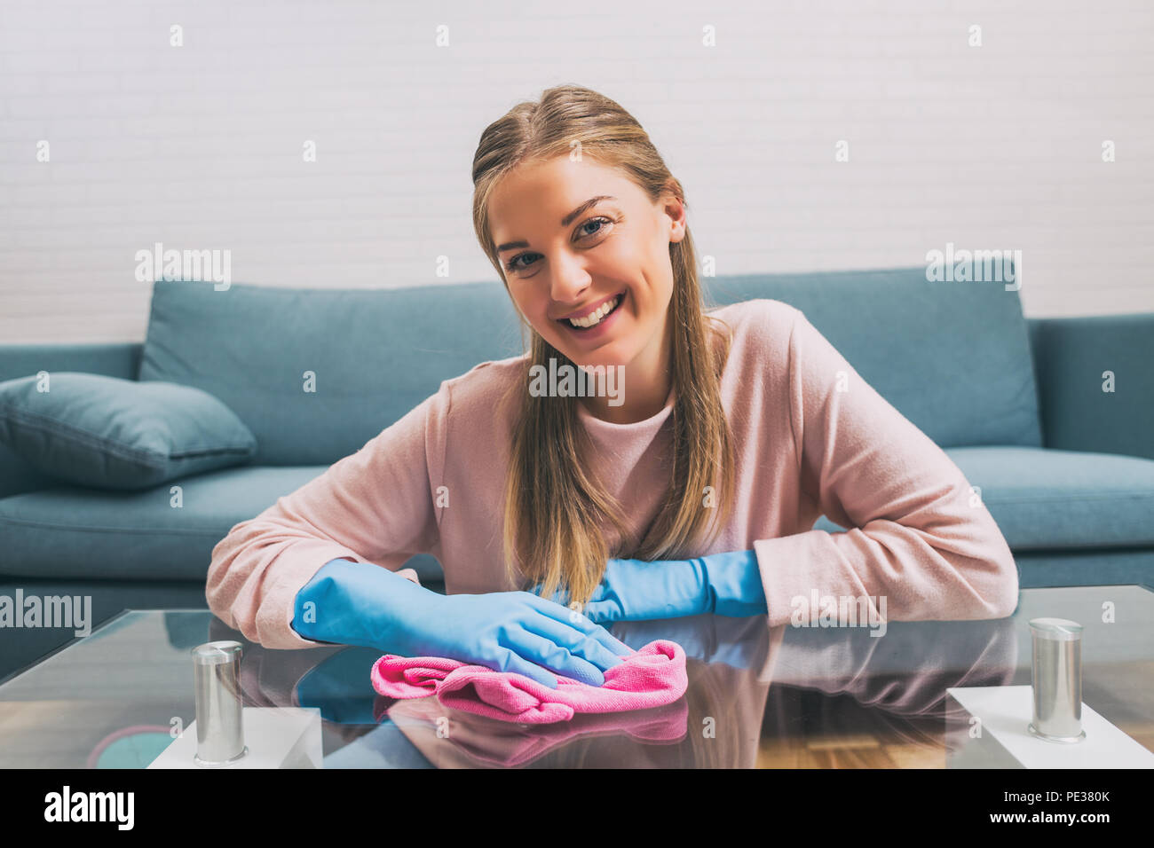 Beautiful woman enjoys cleaning house.Image is intentionally toned. Stock Photo