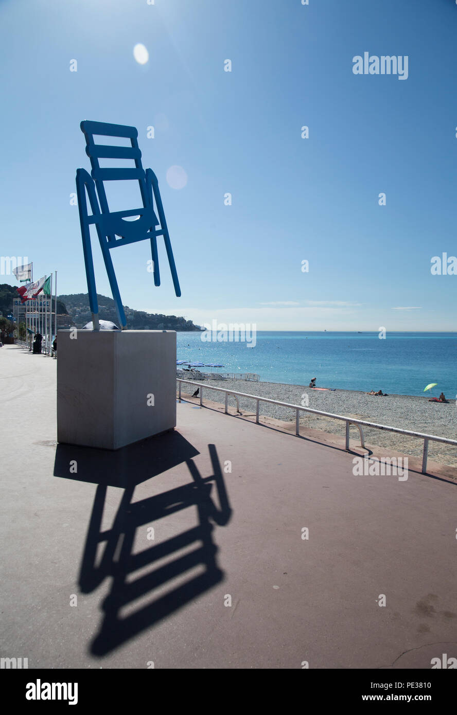 Nice, France, June 2018, A tilted blue metal chair said to be the symbol of Nice is seen on the sea front. Stock Photo