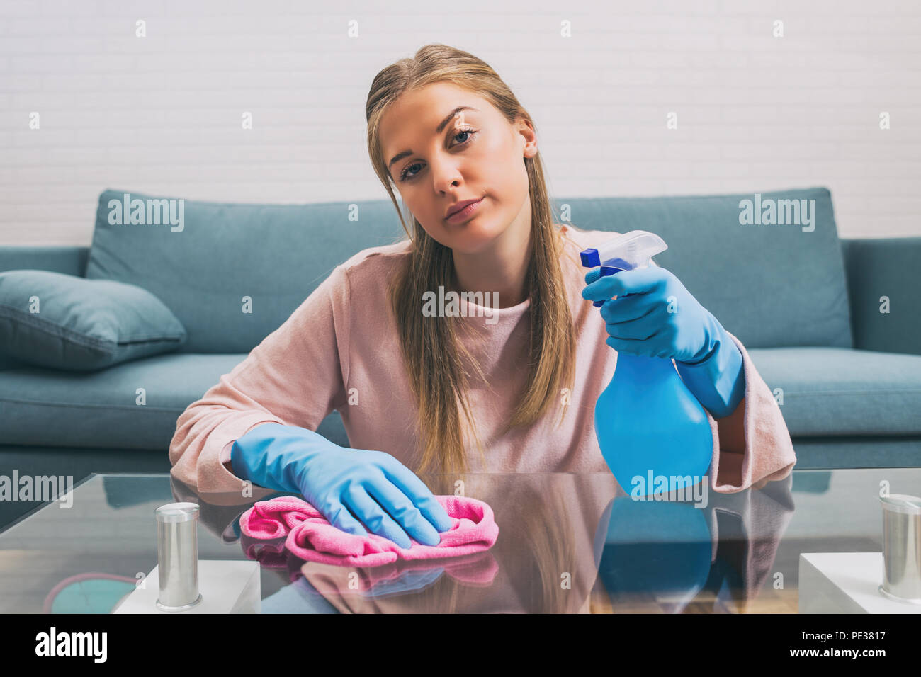 Housewife is sad because she is tired of cleaning and housework. Stock Photo