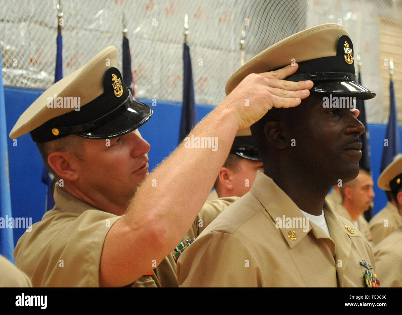 SAN DIEGO (Sep. 16, 2015) Chief Yeoman William Kennedy, attached to the Los Angeles-class fast-attack submarine USS San Francisco (SSN 711), has his combination cover put on by Chief Machinist's Mate Jon-Paul Willett during a chief petty officer pinning ceremony at the Naval Base Point Loma (NBPL) gym. 23 Sailors from various NBPL tenant commands received their anchors during a time-honored naval tradition. (U.S. Navy photo by Yeoman 1st Class Allen Miller/Released) Stock Photo