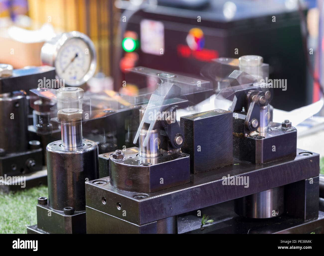 hydraulic clamping jig for machining process ; Blurred from moving component Stock Photo