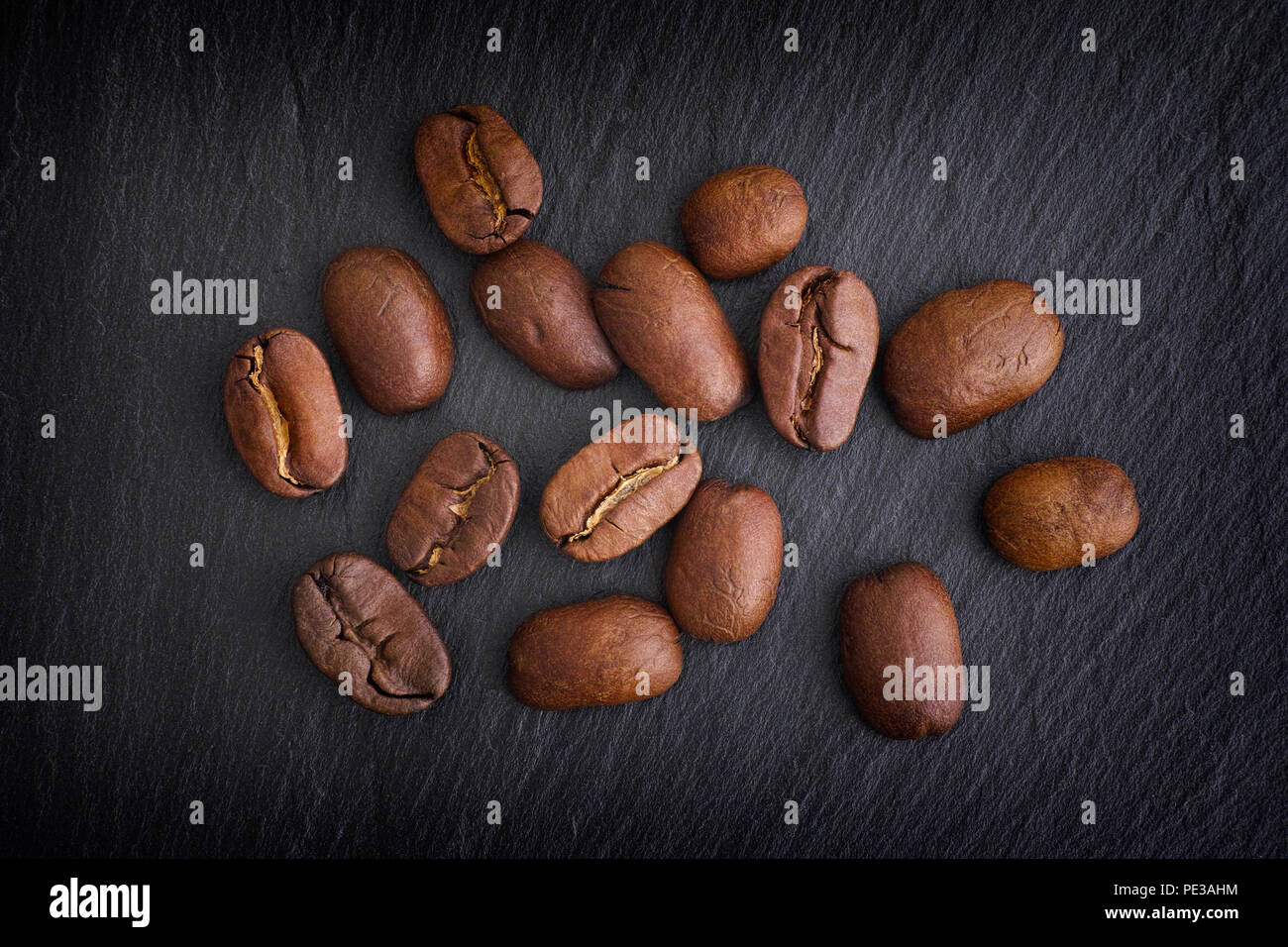 Coffee beans on black slate background. Close up. Stock Photo