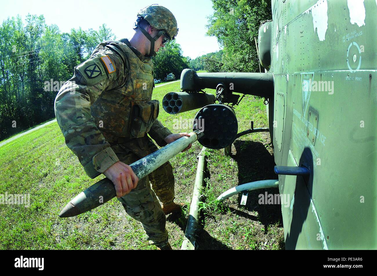 Staff Sgt. Dustin Bussard, 74th Ordnance Company (Explosive Ordnance Disposal) and representing U.S. Army Pacific Command, carefully removes a rocket from the pod of a downed Cobra helicopter (simulated) during an event of the EOD Team of the Year Competition Sept. 17 at Fort A.P. Hill. Bussard’s team, which included Spc. Matthew Hamilton and Cpl. Ryan Voss, beat out five others to win the title. The 74th is an element of the 303th Ordnance Battalion, 45th Sustainment Brigade, 8th Theater Support Command, located at Schofield Barracks, Hawaii. Stock Photo