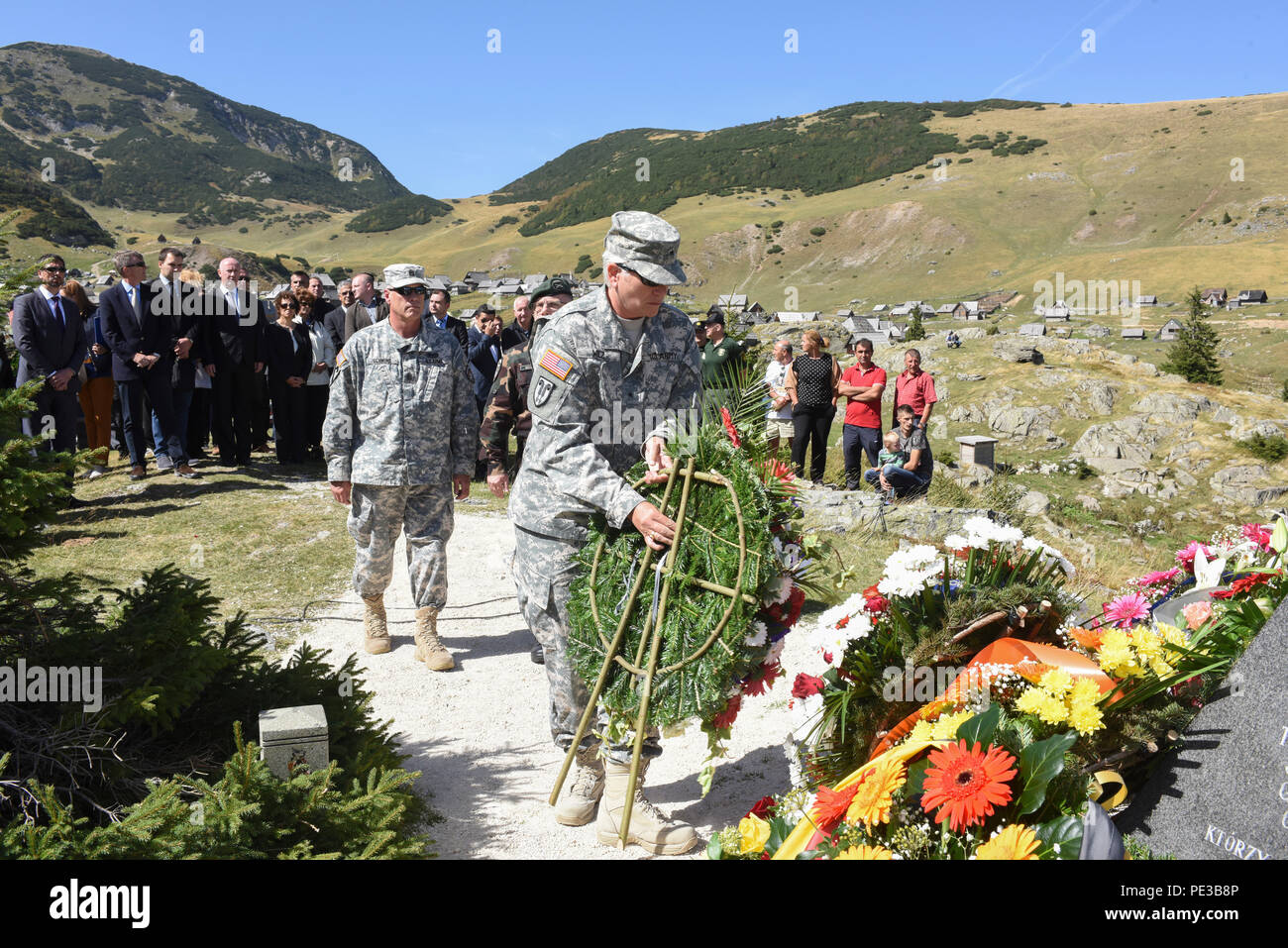 U.S. Army Brig. Gen. Giselle Wilz, NATO Headquarters Sarajevo commander, places a wreath at a memorial site as Command Sgt. Maj. Harley Schwind, NHQSa command senior enlisted leader, looks on Sept. 17, 2015. Members paid respects during a memorial ceremony at Fojnica, Bosnia and Herzegovina. On Sept. 17, 1997, 12 people were killed and four injured when a helicopter carrying a United States delegation slammed into a fog-shrouded Bosnian mountainside. (U.S. Air Force photo by Master Sgt. JT May III) Stock Photo