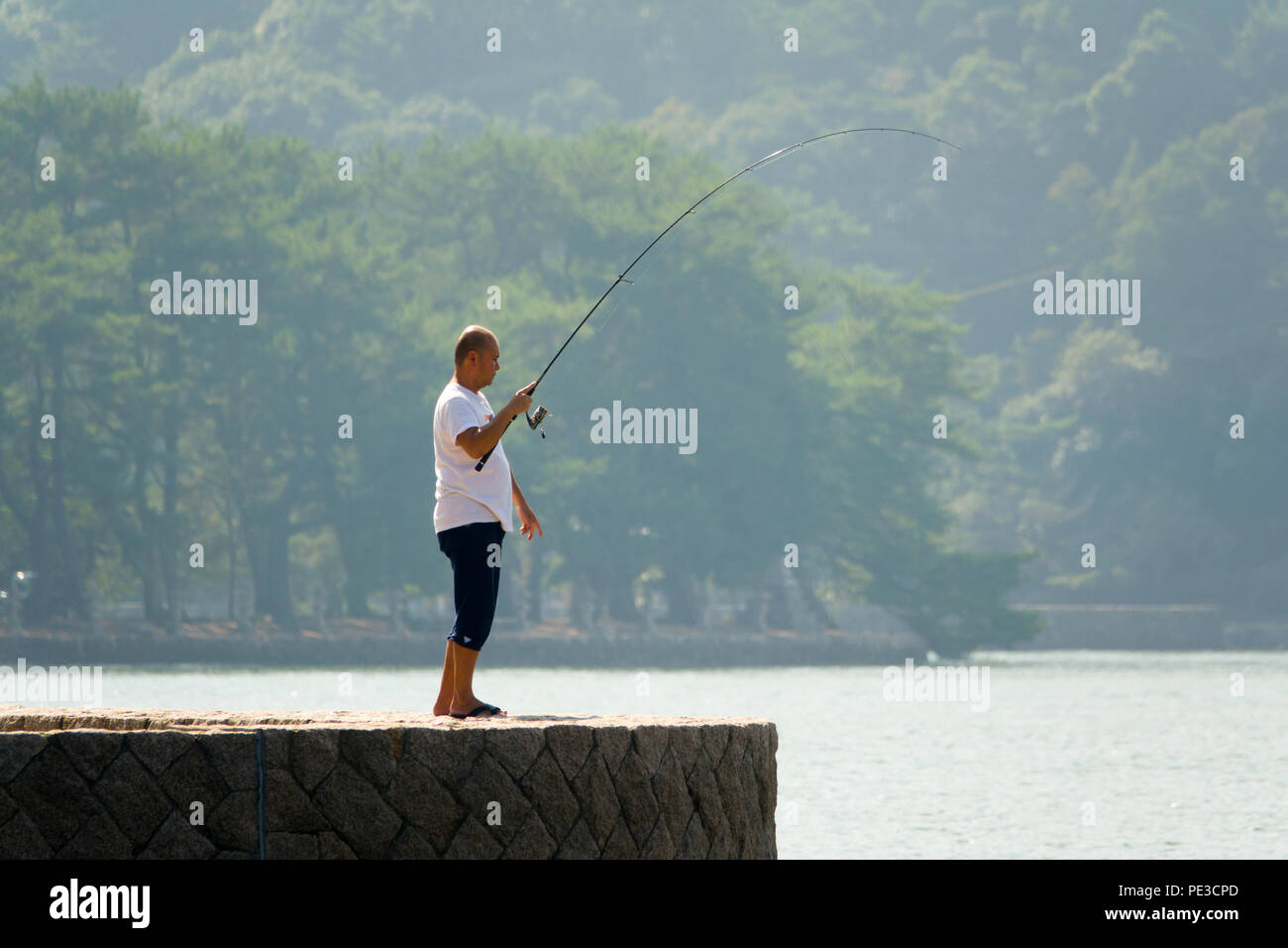 Asian fisherman on Miyajima Island of Gods Hiroshima Japan Asia Stock Photo