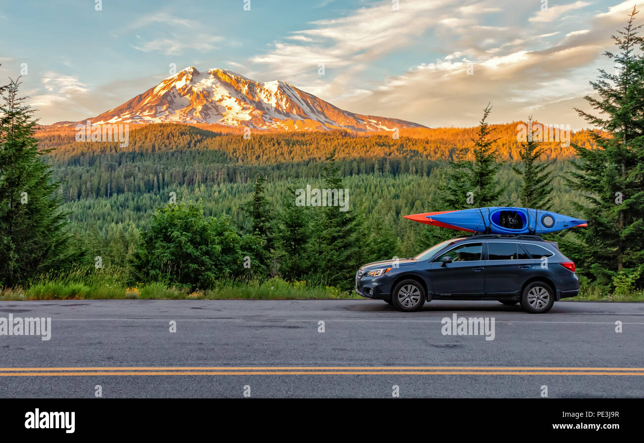 Gifford Pinchot National Forest, Washington - July 13, 2018:  SUV with Kayaks in front of Mt. Adams at sunset Stock Photo