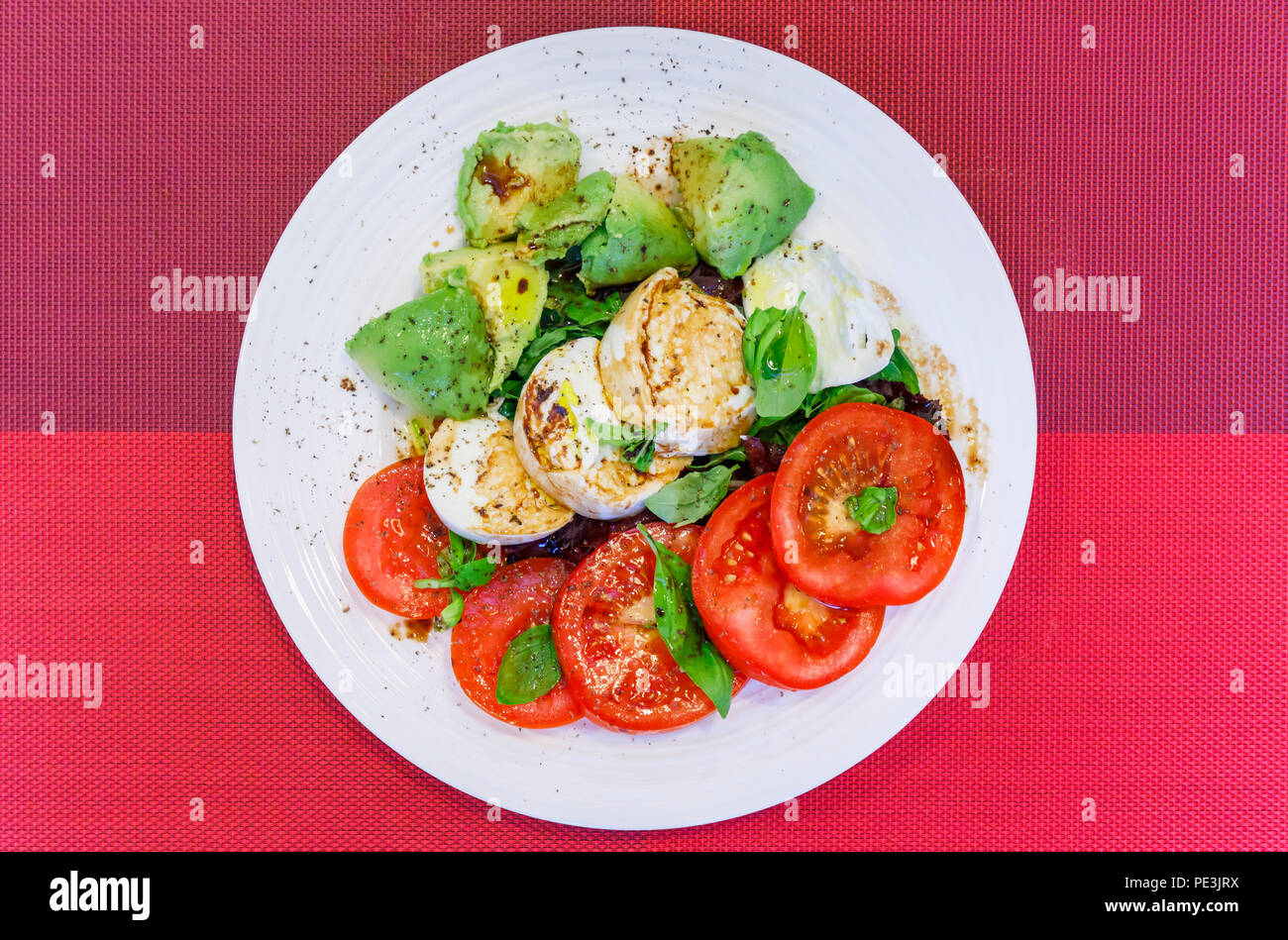 Healthy lifestyle typical Mediterranean diet, tricolore salad ingredients sliced red tomatoes