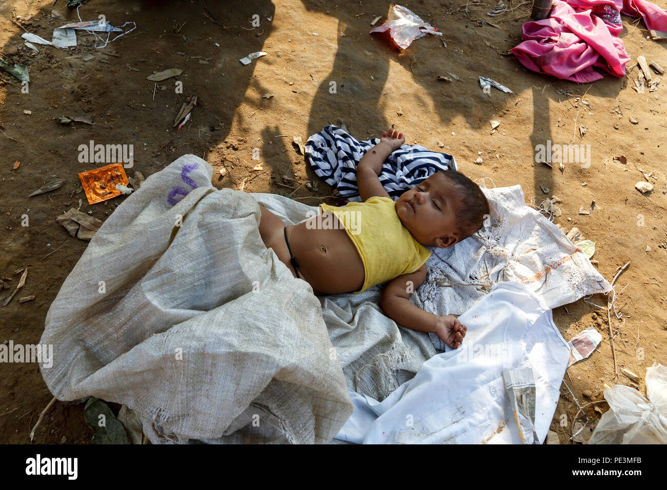 A Rohingya refugee child sleeping inside a makeshift at Balukhali, Cox's Bazar, Bangladesh Stock Photo