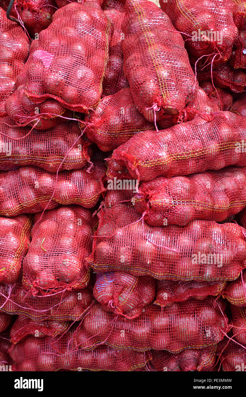 Sacs containing Large onion stacked for sale at Local Market at Little  India, Singapore Stock Photo - Alamy