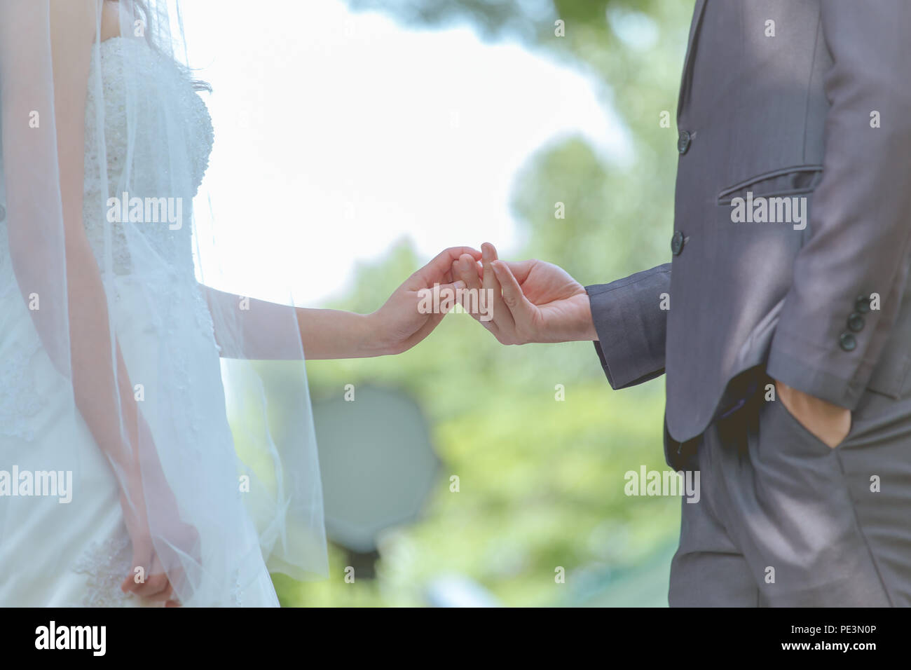 Married bride and groom holding hands as a symbol of love and happiness. Stock Photo