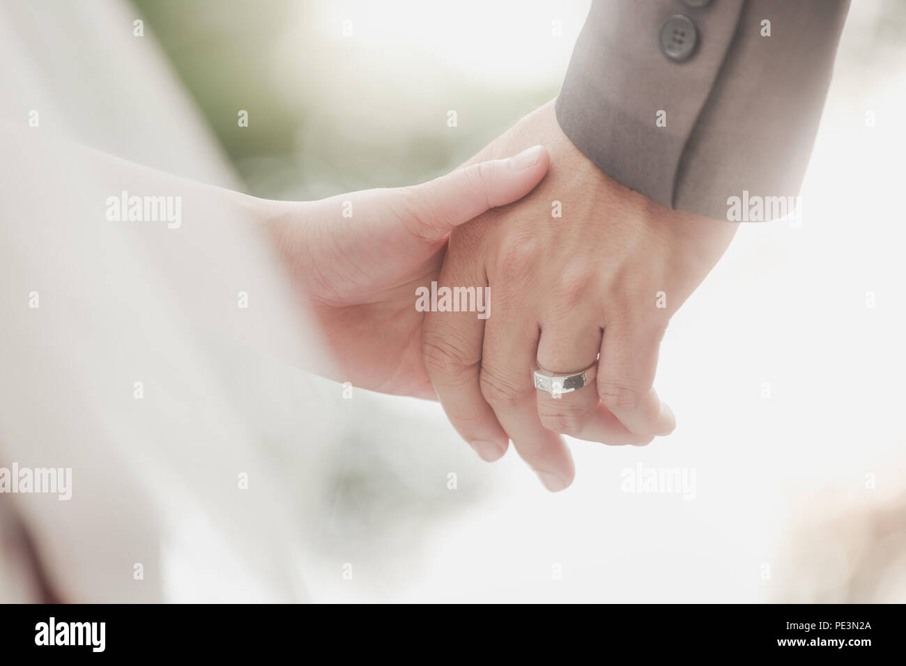 Married bride and groom holding hands as a symbol of love and happiness. Stock Photo