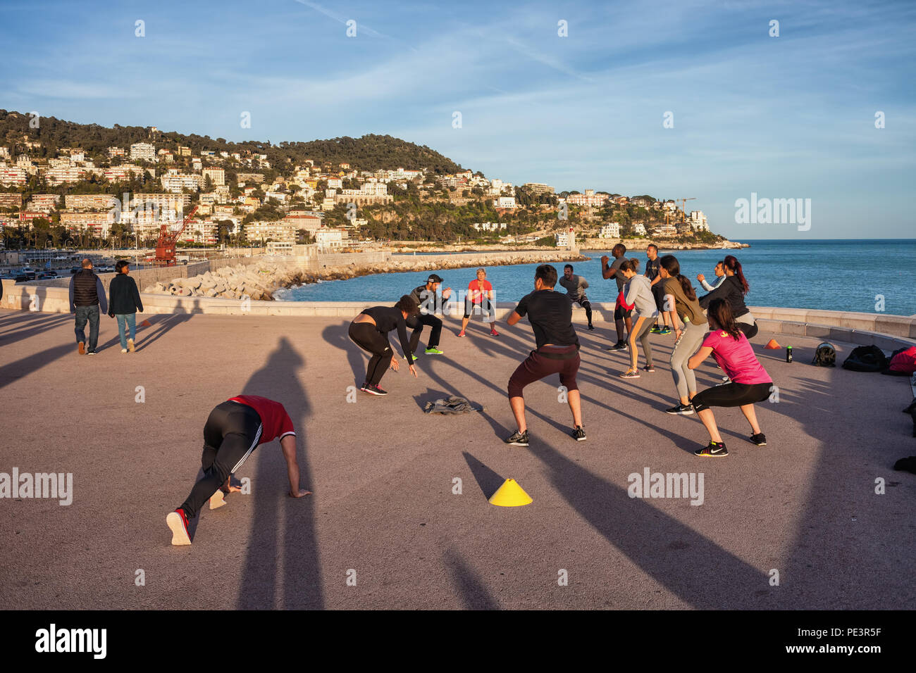 People in outdoor aerobic class training on sea promenade in city of Nice on French Riviera in France Stock Photo