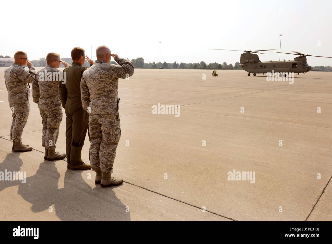 From the right, Brig. Gen. John D. Slocum, 127th Wing commander; Col. Douglas Champagne, 127th Operations Group commander; Col. Rolf Mammen, 127th Wing vice commander and Maj. Kurt Ring, 127th Aircraft Maintenance Squadron commander, salute two CH-47 Chinook helicopters transporting seven members of Congress who toured Selfridge Air National Guard Base on Sep. 2, 2015. In an historic visit, seven members of Congress toured Selfridge ANGB to gain insight into the diverse missions, capabilities and the future potential of the base. (Air National Guard photo by Master Sgt. David Kujawa/Released) Stock Photo