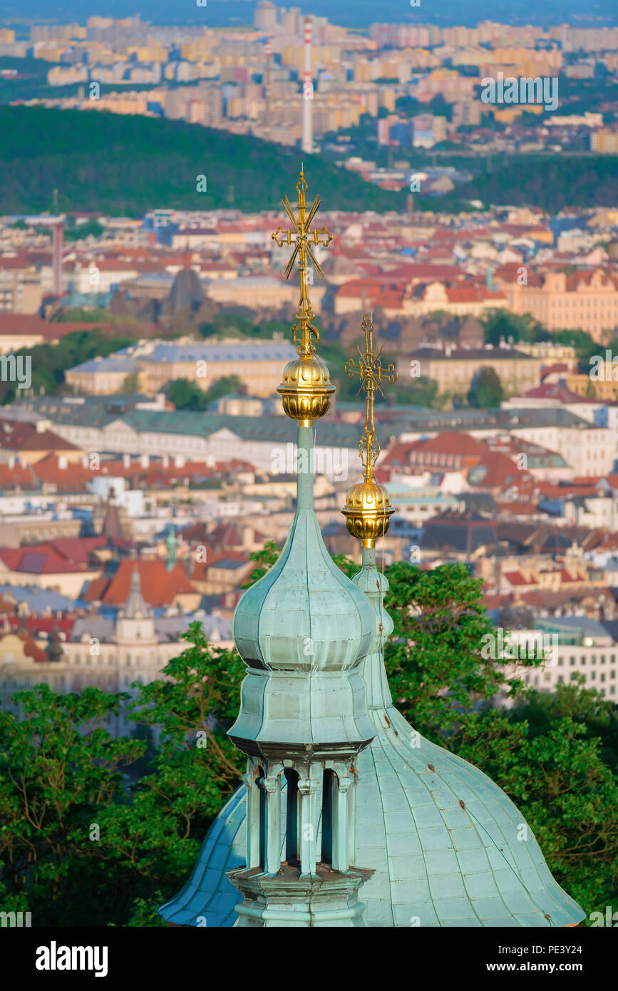 Prague view city, aerial view of onion domes on top of St Lawrence Church on Petrin Hill, against the backdrop of the Nove Mesto district, Prague. Stock Photo