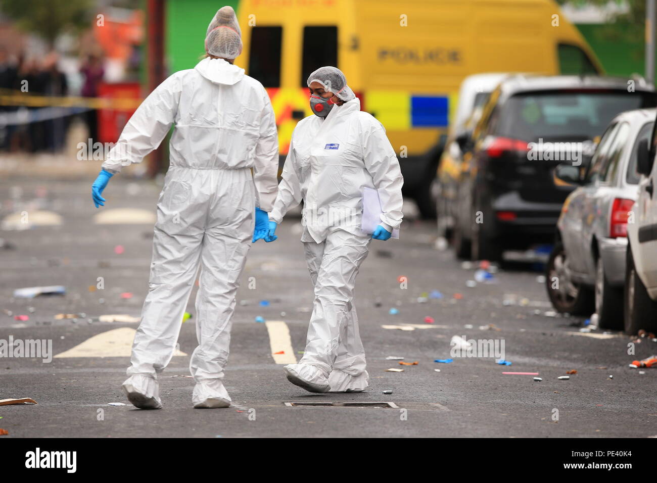 Forensics officers at the scene in Claremont Road, Moss Side