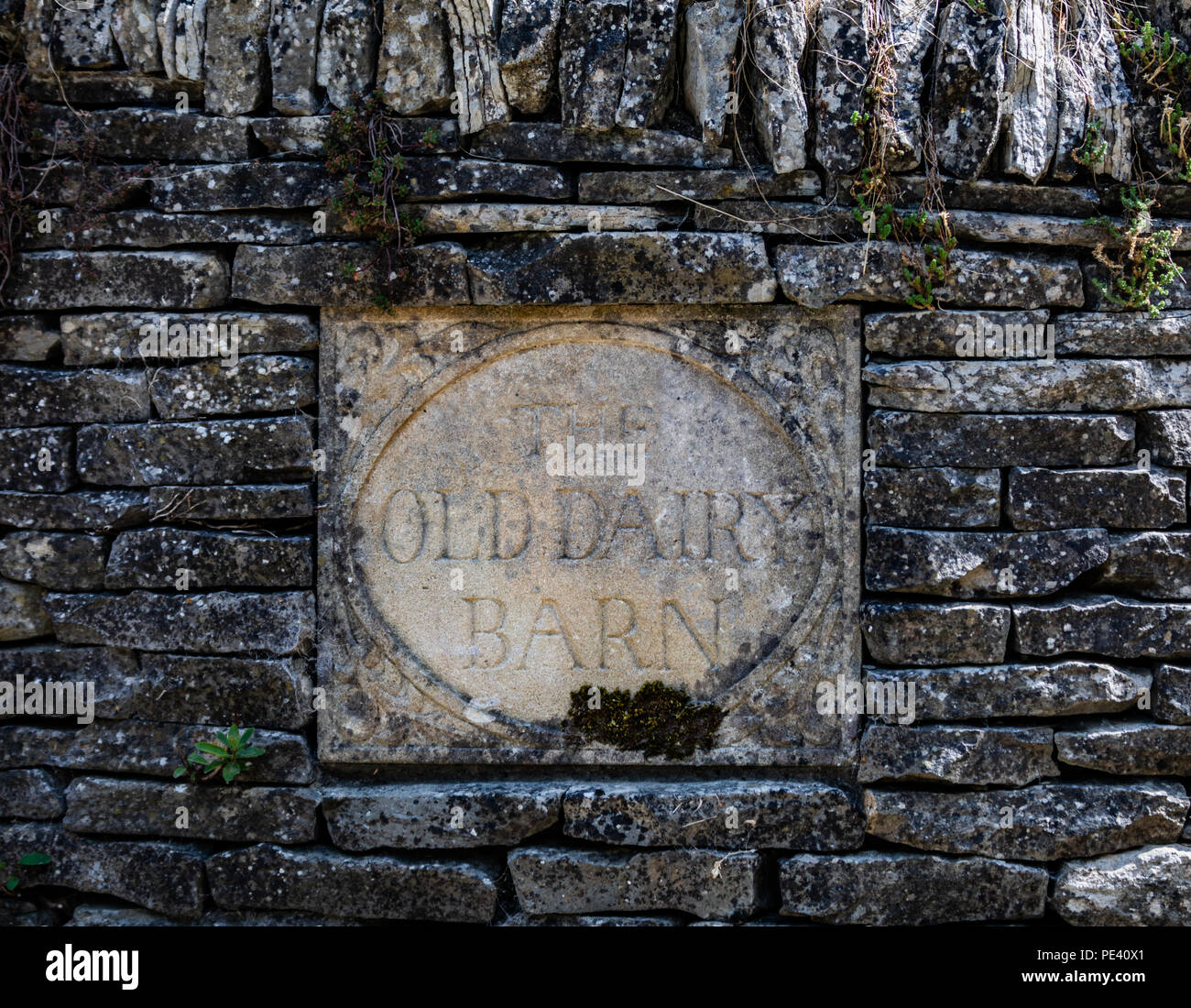 Old Sign Using Stone The Old Dairy Barn stone sign in a stone wall, Cotswolds, England Stock ...