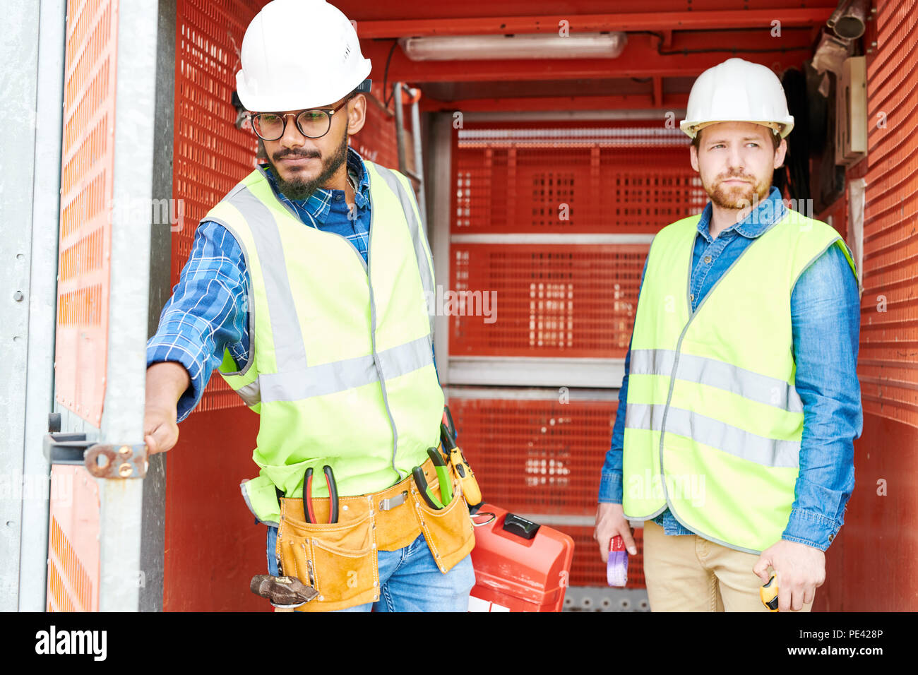 Construction engineers in industrial elevator Stock Photo Alamy