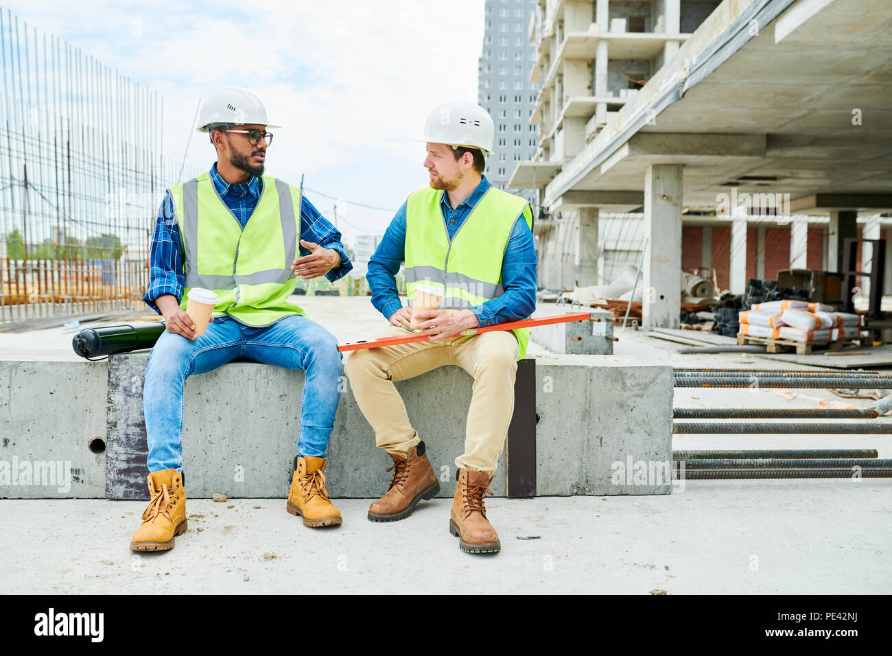 Construction engineer telling story to colleague Stock Photo