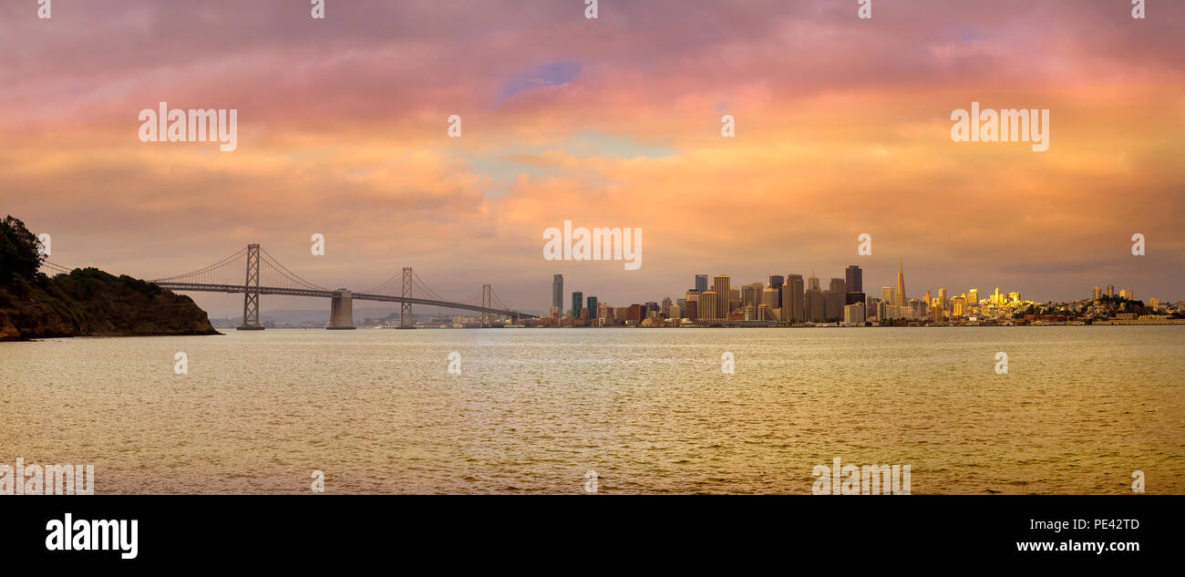 San Francisco city skyline and Oakland Bay Bridge during sunset panorama Stock Photo