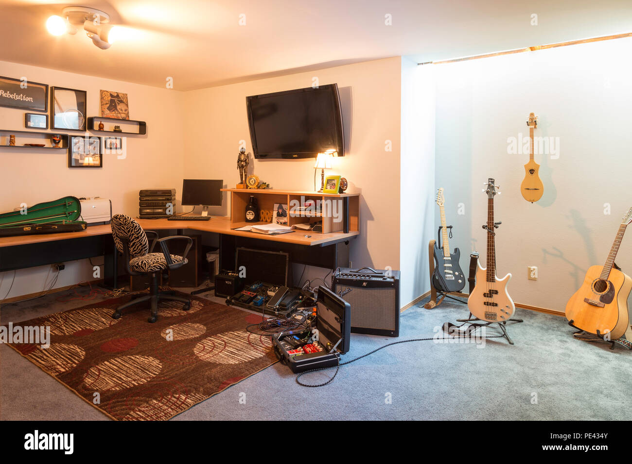 Music studio full of instruments and pc display Stock Photo - Alamy