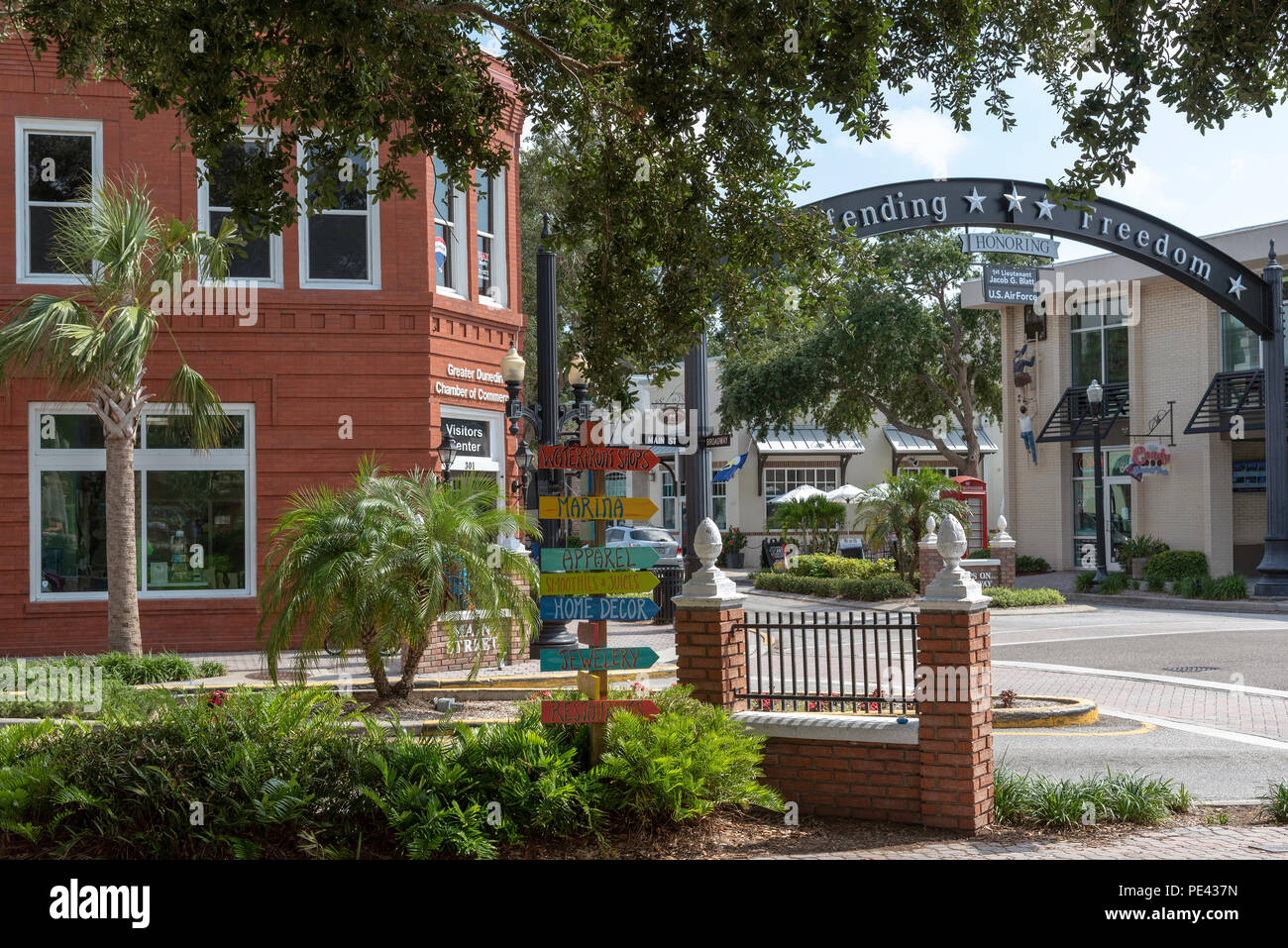 Dunedin town centre, Florida, USA with an overhead sign. Defending Freedom. Stock Photo