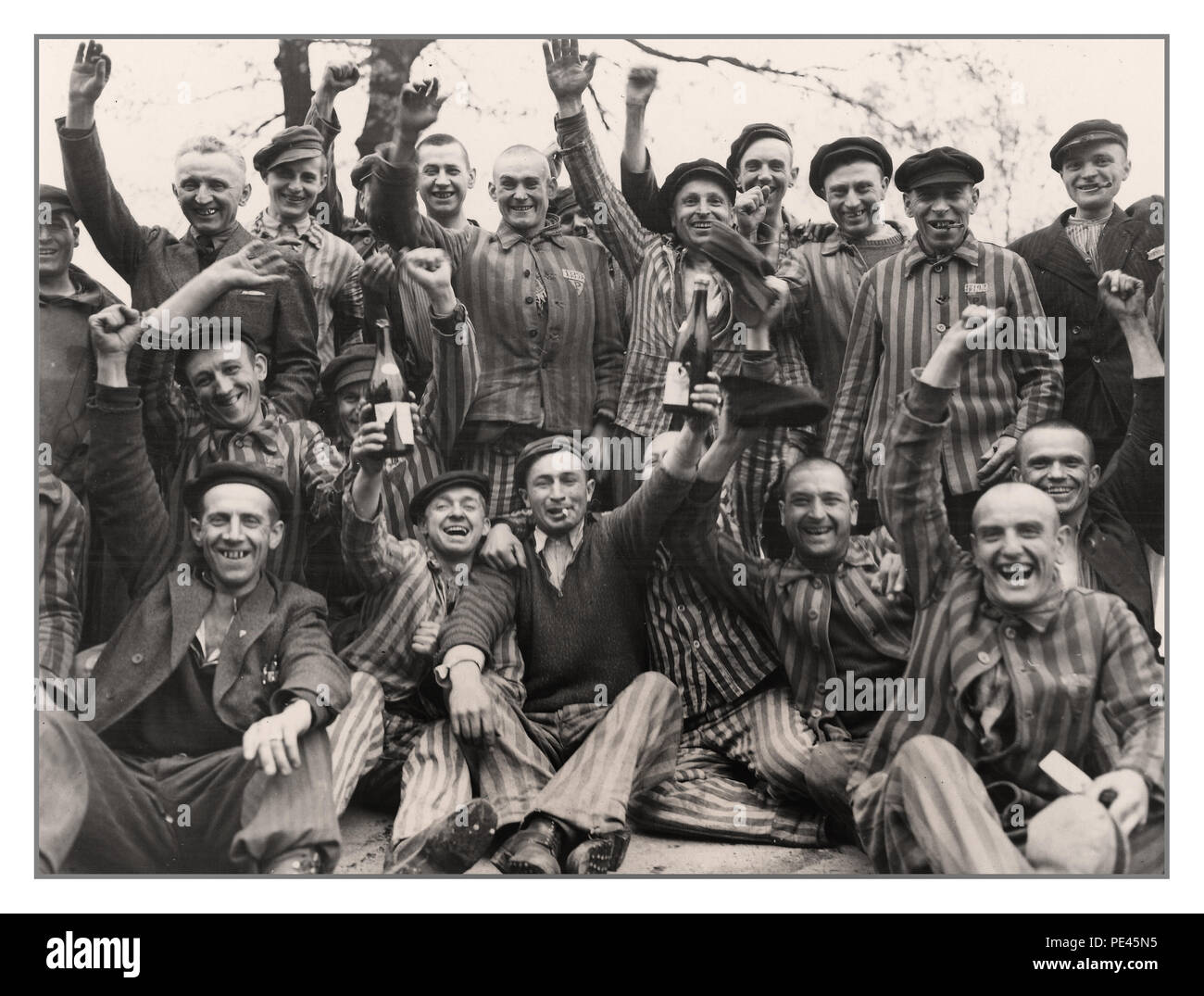 DACHAU LIBERATION Polish prisoners in Dachau concentration camp, some in striped uniform celebrating their liberation when Allied soldiers liberated the camp April 29, 1945, Dachau was surrendered to Brig. Gen. Henning Linden of the 42nd Infantry Division U.S. Army by Untersturmführer Wicker. during World War II Gen. of the Army Dwight D. Eisenhower issued a communiqué regarding the capture of Dachau concentration camp: 'Our forces liberated & mopped up the infamous concentration camp at Dachau. Approximately 32,000 prisoners were liberated; 300 SS camp guards were quickly neutralized. Stock Photo