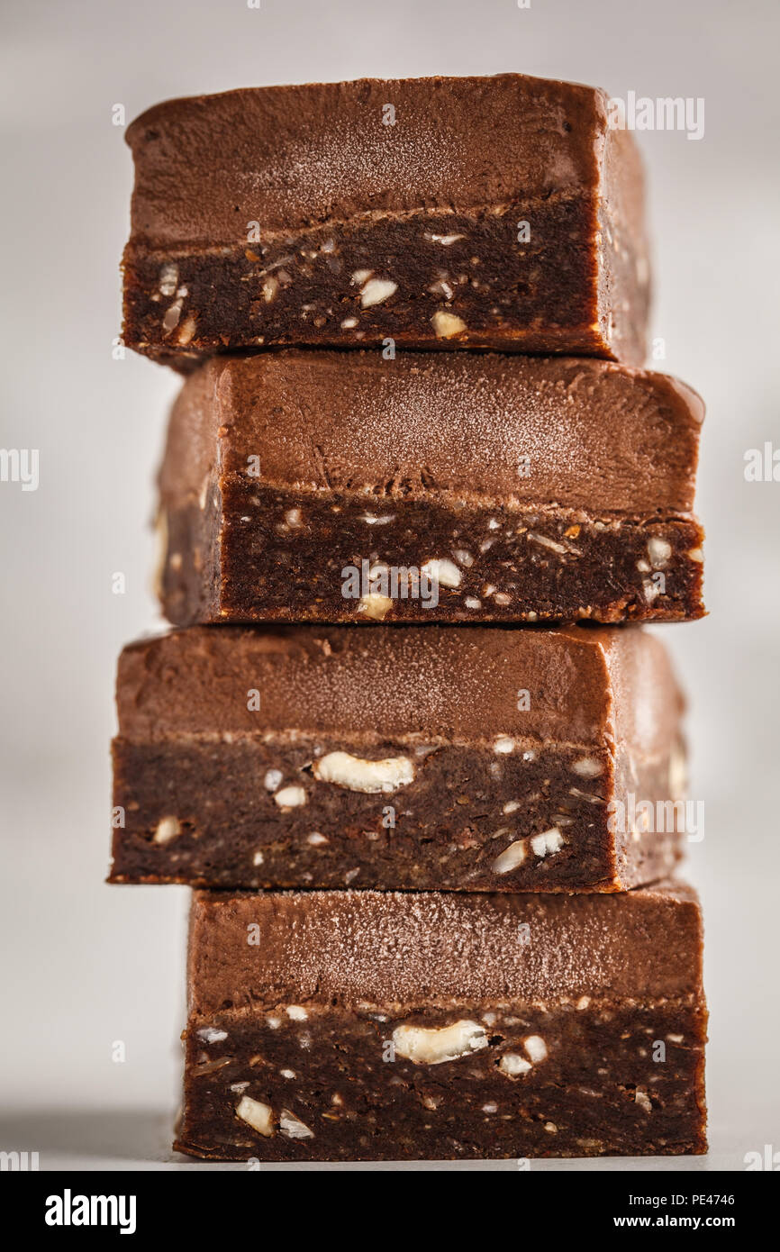 Stack of chocolate fudge bars on white background. Clean eating concept