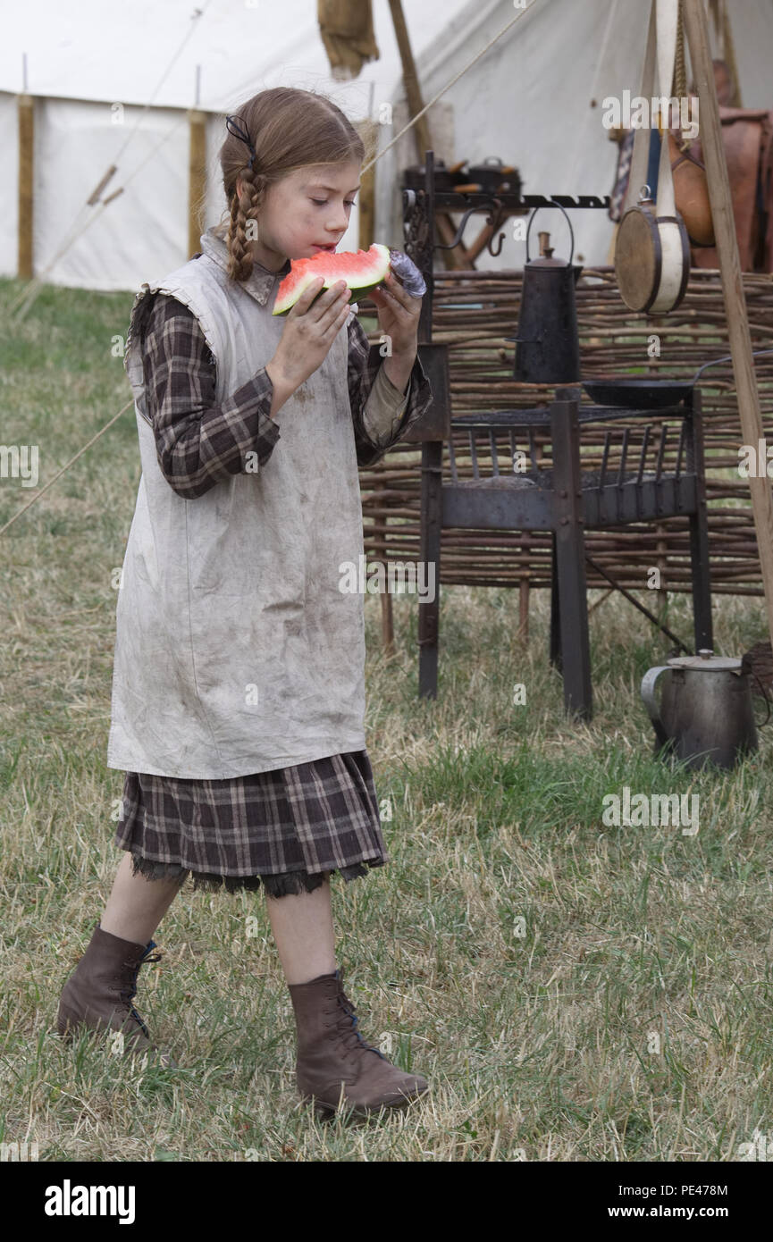 Ragged Victorian child eating a water melon Stock Photo