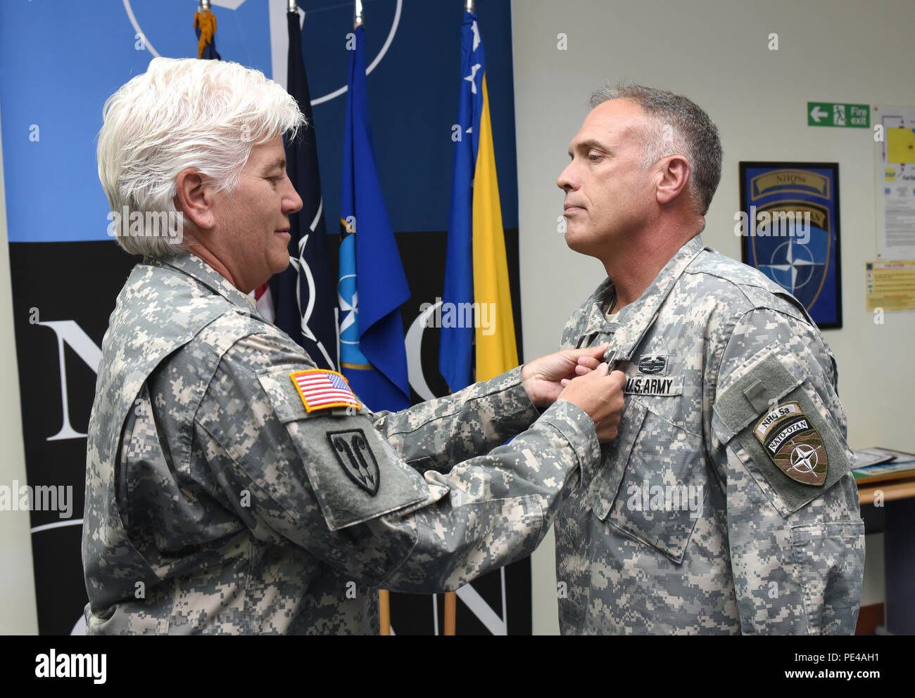 U.S. Army Brig. Gen. Giselle Wilz, NATO Headquarters Sarajevo commander, awards Command Sgt. Maj. Harley Schwind, NHQSa command senior enlisted leader, with the Legion of Merit Medal Sept. 7, 2015, at Camp Butmir in Sarajevo, Bosnia and Herzegovina. Schwind received the medal for exceptionally meritorious service to the North Dakota Army National Guard. He also received the state Legion of Merit Medal.  (U.S. Air Force photo by Master Sgt. JT May III) Stock Photo