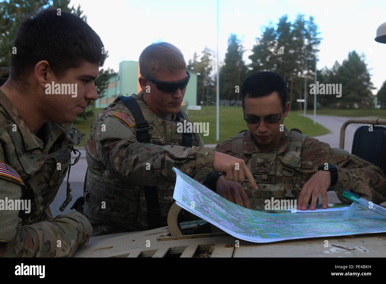 Spc. Skylar M. McMahon (left to rigth), Pvt. Michael V. Bonham, and Cpl. Evan A. Marroquin, Soldiers assigned to Destined Company, 2nd Battalion, 503rd Infantry Regiment, 173rd Airborne Brigade, plot coordinates on a map during a land navigation course exercise in Voru, Estonia, Sept. 9, as part of Swift Bayonet, a training exercise that is part of Operation Atlantic Resolve. The hands-on practical exercises ensured confidence for real-world scenarios factoring in weather and terrain. (U.S. Army photo by Spc. Jacqueline Dowland, 13th Public Affairs Detachment) Stock Photo