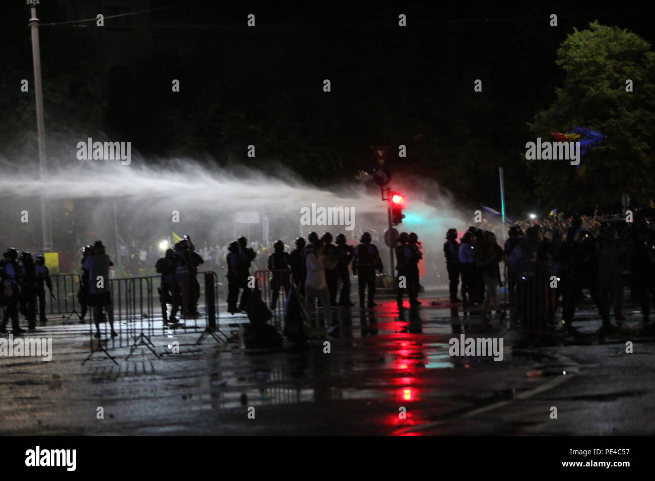 Bucharest, Romania - August 10, 2018:  Water cannons are used during the violent anti-government protest in Bucharest. Stock Photo