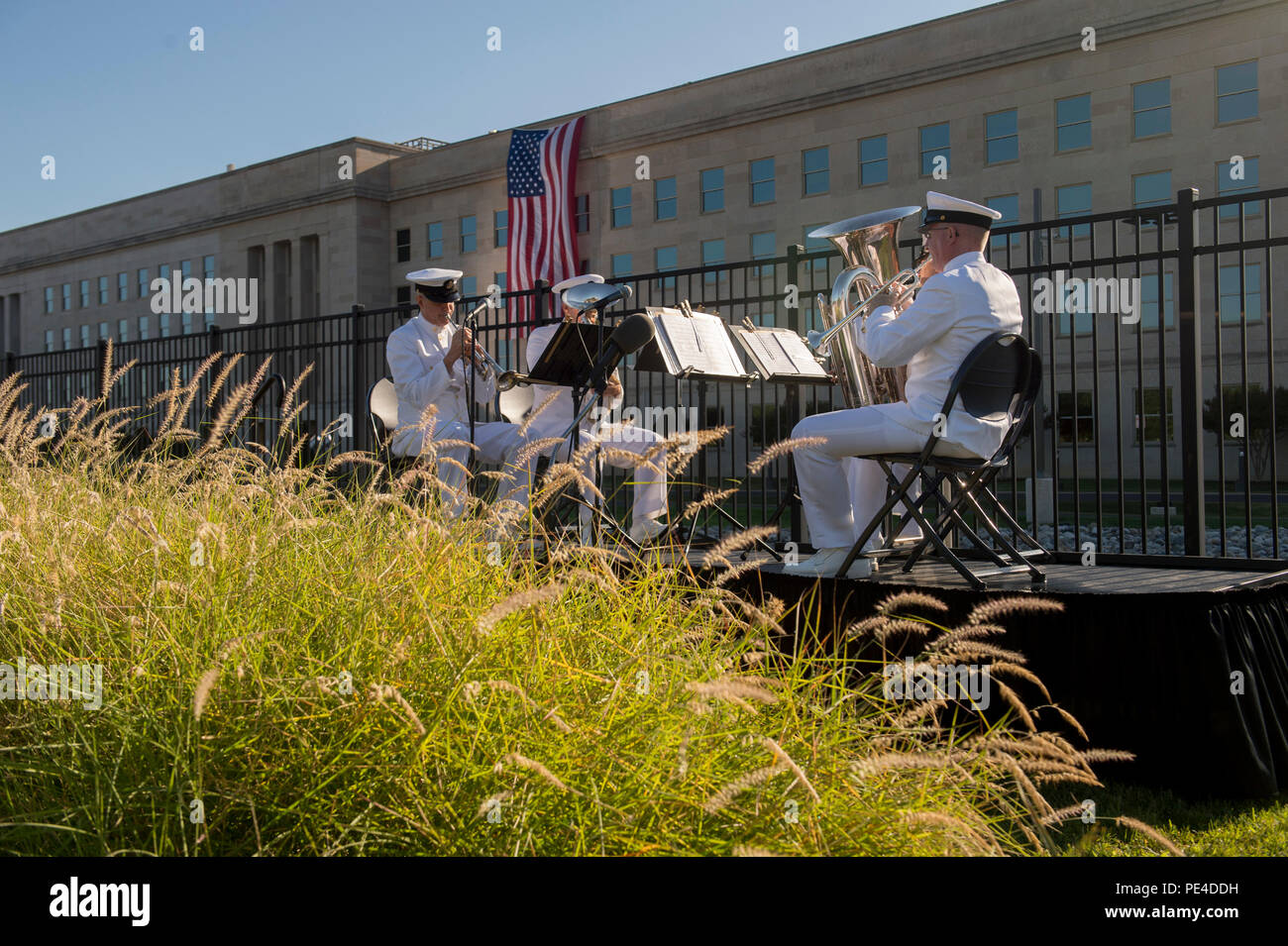 A Navy band plays music as Defense Secretary Ash Carter and Air Force Gen. Paul Selva, vice chairman of the Joint Chiefs of Staff, host a remembrance ceremony Sept. 11, 2015, at the Pentagon Memorial to honor the memory of those killed in the 9/11 terrorist attack. The ceremony was attended by family members who lost loved ones. (DoD photo by Senior Master Sgt. Adrian Cadiz)(Released) Stock Photo