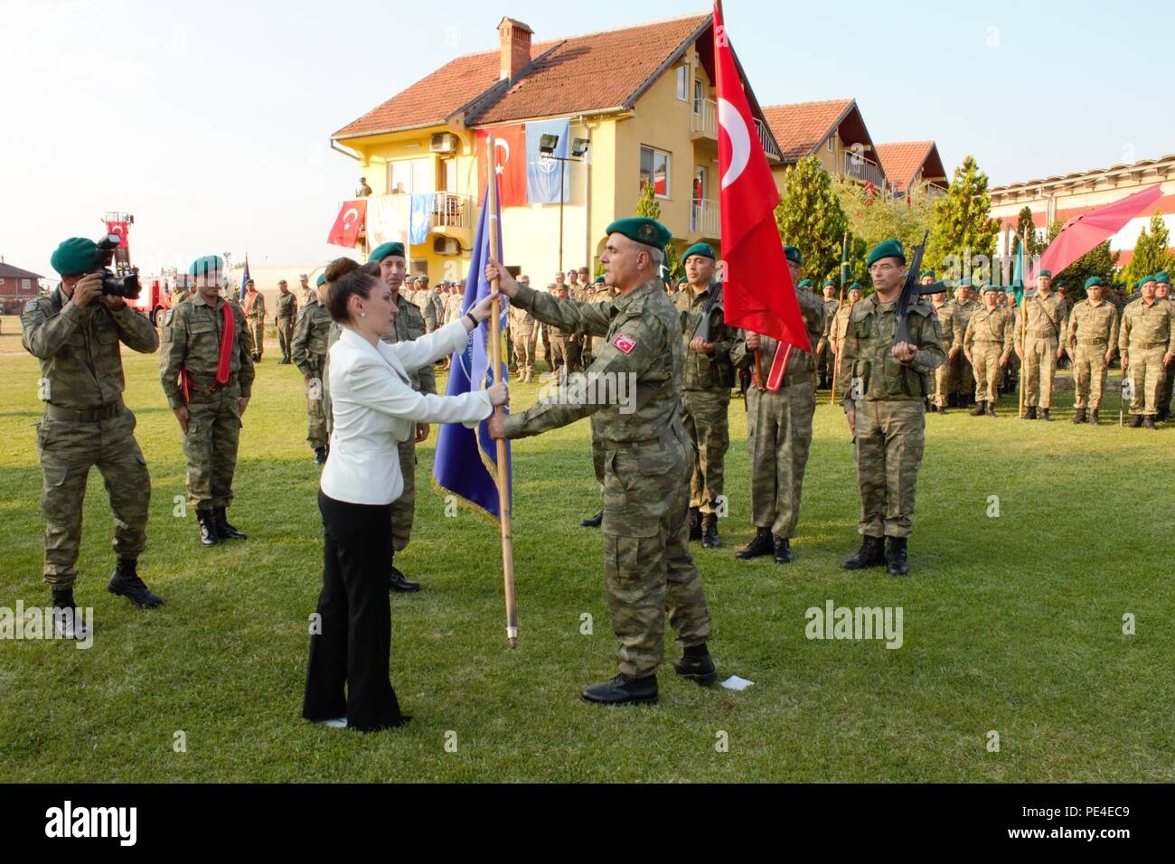 Turkey’s ambassador to Kosovo, Kivilcim Kilic, presents an honorary flag for the Turkish National Command Contingent to Kosovo to Col. Omer Faruk Demircioglu during his change of command ceremony Sept. 3, 2015, in Prizren, Kosovo. During the ceremony, Turkish Col. Saim Bagci assumed the command’s top post. JRD-S and its liaison monitoring teams are part of NATO’s peace support mission in the region, known as Kosovo Force.. (U.S. Army photo by Sgt. Erick Yates, Multinational Battle Group-East) Stock Photo
