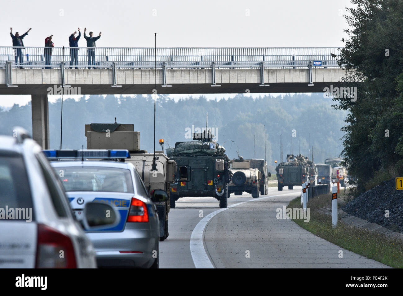 Local Czech Republic residents cheer on Troopers assigned to 4th Squadron, 2nd Cavalry Regiment, while watching them participate in Dragoon Crossing, a tactical road march starting out at Rose Barracks, Germany and continuing through the Czech Republic and the Slovak Republic ending in Hungary Sept. 13, 2015. The purpose of the exercise is to reassure NATO allies of the U.S. intent during Operation Atlantic Resolve while demonstrating interoperability and freedom of movement throughout Eastern Europe. (U.S. Army photo by Sgt. William A. Tanner/released) Stock Photo