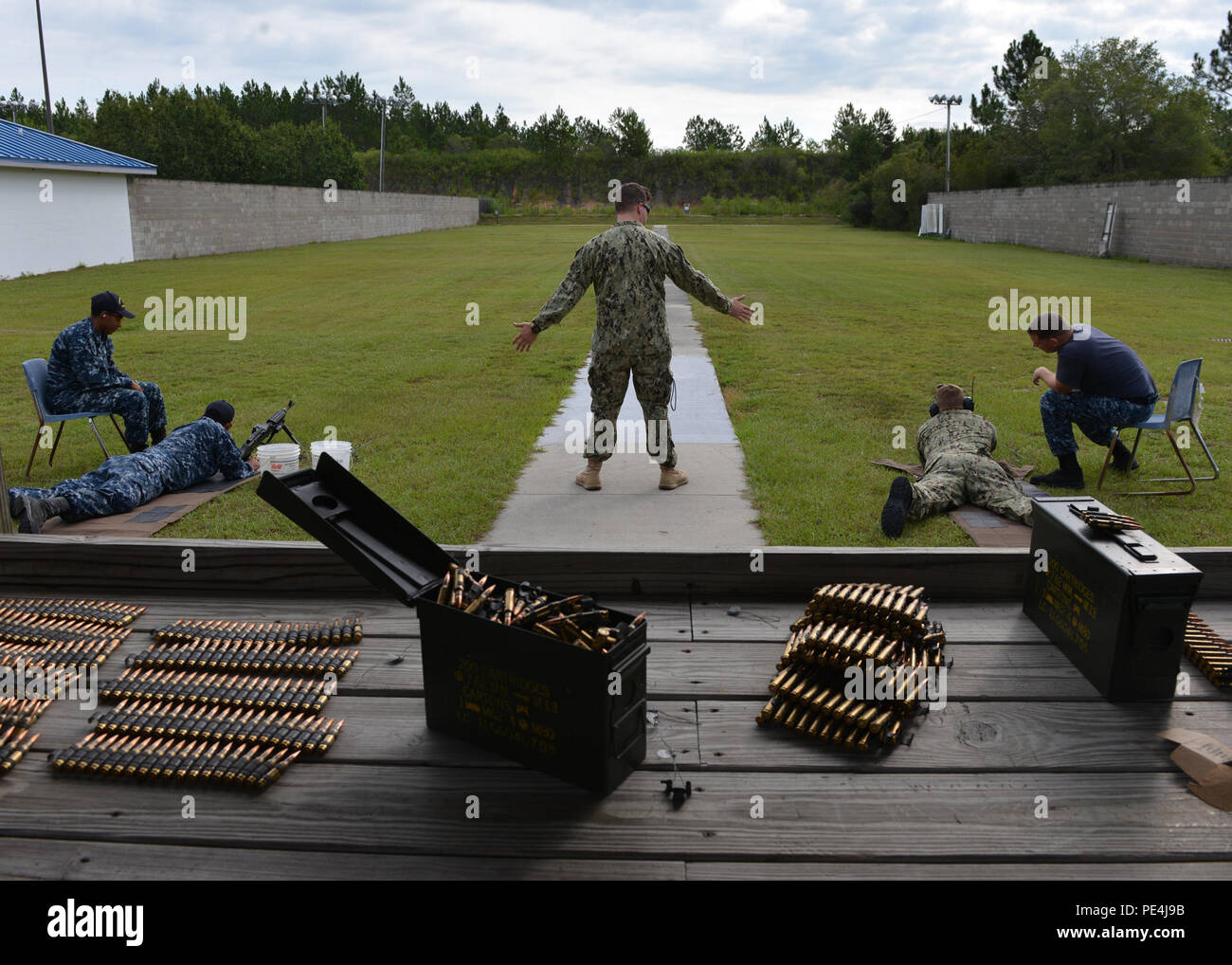 150915-N-TI693-072 SOUTHPORT Fla. (September 15, 2015) - Mineman 1st Class Kevin Bushlow, Leading Petty Officer for the Naval Support Activity Panama City (NSA PC) armory, from Woodbridge, Va., readies the Sailors about to fire the M240-Bs down range. Sailors from various tenant activities aboard NSA PC conduct their semi-annual Navy firearms qualification at the Gulf Coast State College firing range. U.S. Navy Photo by Mass Communication Specialist 2nd Class Fred Gray IV. (RELEASED) Stock Photo