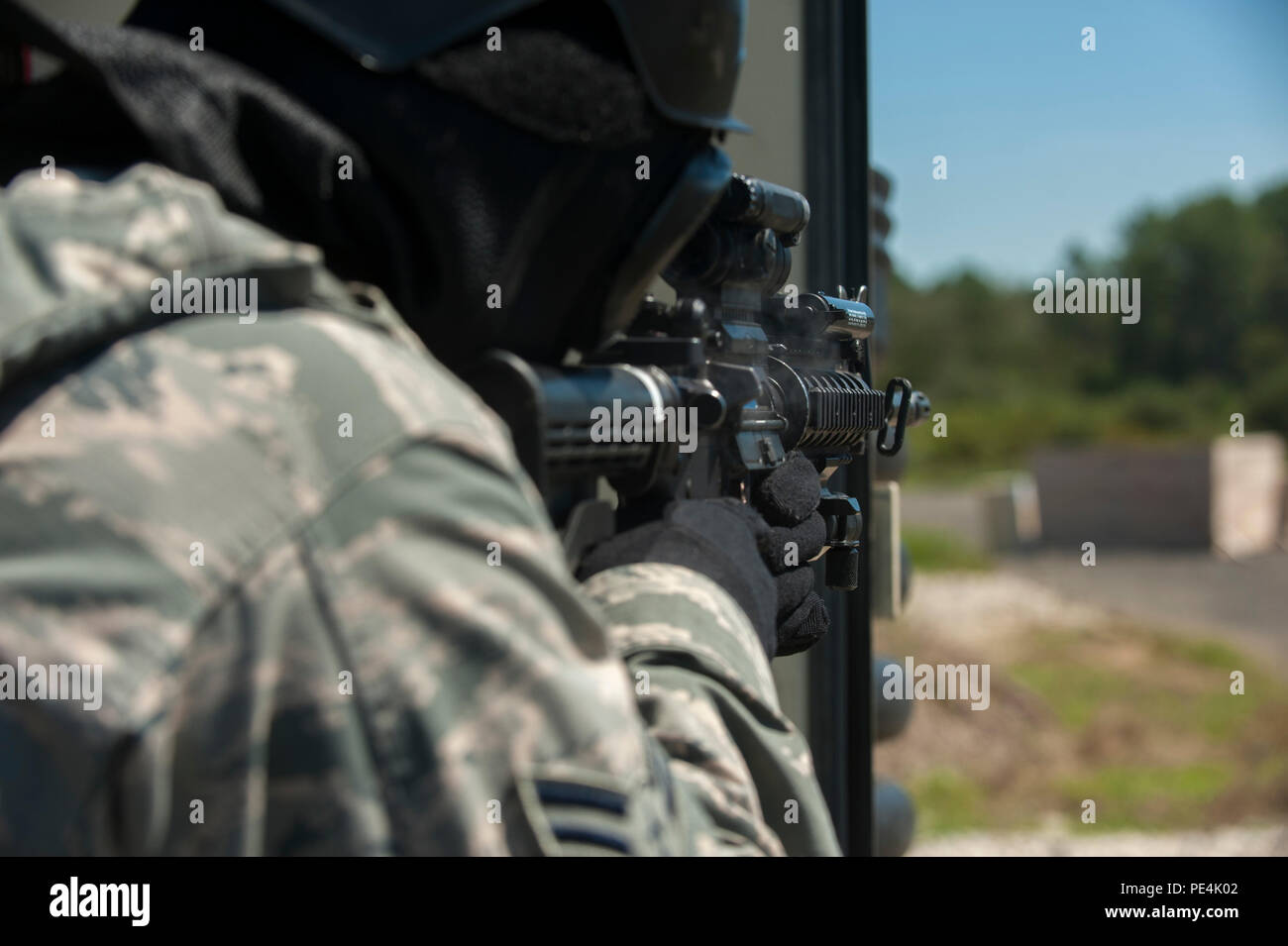 A defender from the 19th Security Forces Squadron fires an M4 carbine ...