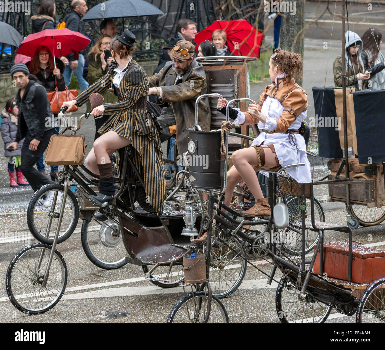 Women and man biking oversized tricycles hires stock photography and