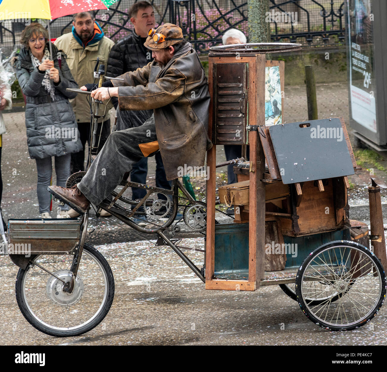 Man biking oversized tricycle, Strasbourg carnival parade, Alsace, France, Europe, Stock Photo