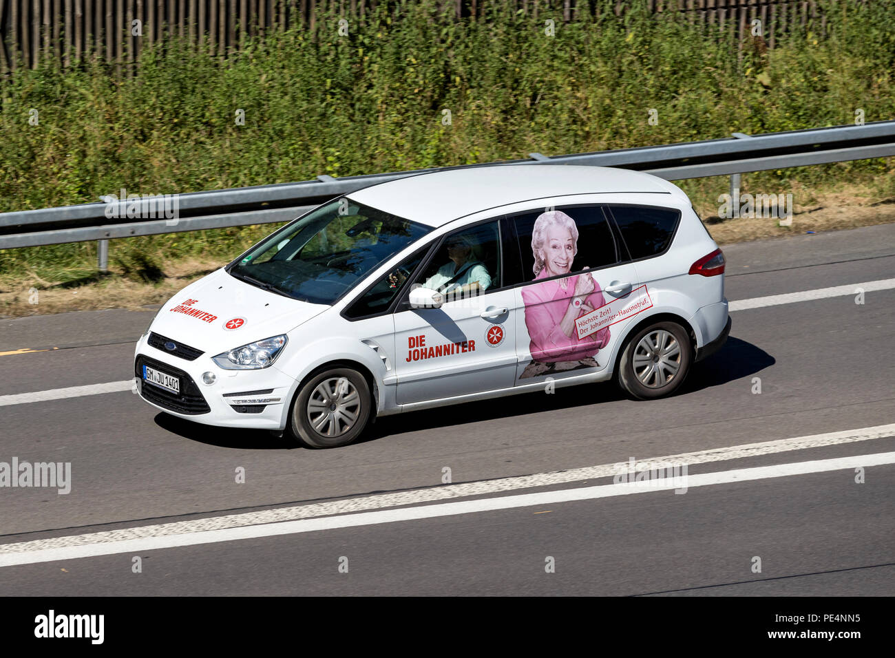 Johanniter car on motorway. Die Johanniter is a voluntary humanitarian organisation. Stock Photo