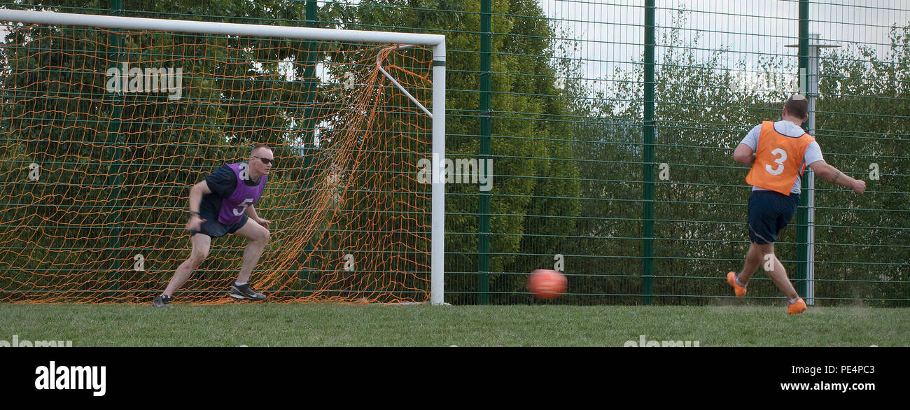 An Airman shoots a penalty kick during the soccer tournament for the Commander’s Challenge Sept. 9, 2015, at Ramstein Air Base, Germany. The 86th Vehicle Readiness Squadron took first place against 10 other competing units in this tournament. (U.S. Air Force photo/Airman 1st Class Larissa Greatwood) Stock Photo