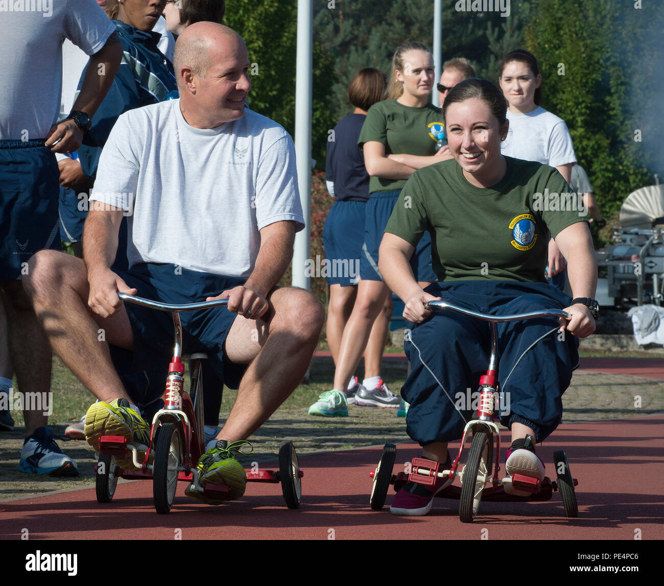 Airmen compete during a tricycle relay as part of the Commander’s Challenge Sept. 9, 2015, at Ramstein Air Base, Germany. The Commander’s Challenge gives Airmen the opportunity to build camaraderie with their co-workers and Airmen from different units as well as learn the importance of resiliency. (U.S. Air Force photo/Airman 1st Class Larissa Greatwood) Stock Photo
