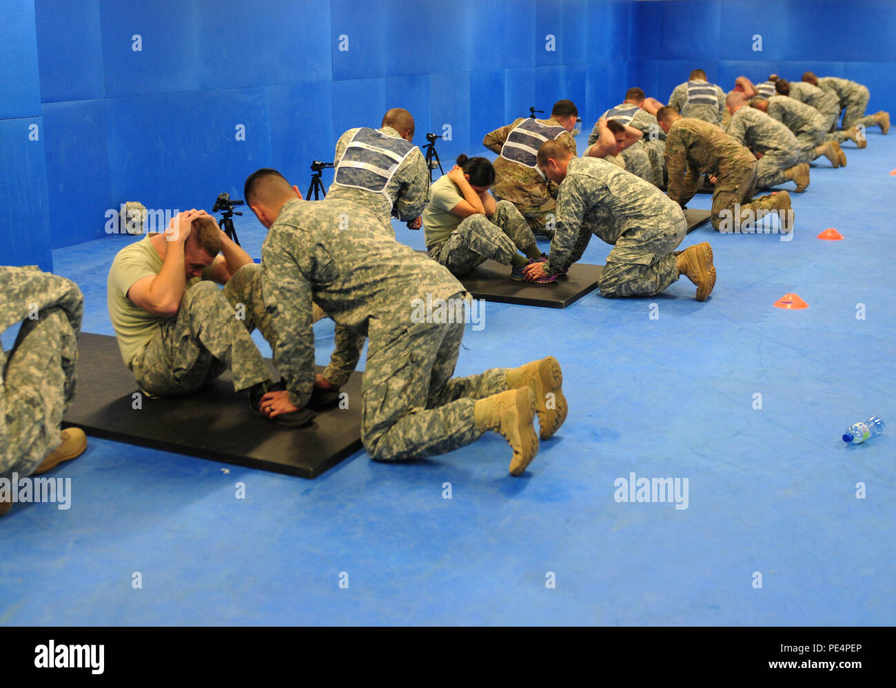 NCOs from across U.S. Army Europe perform sit ups as part of the