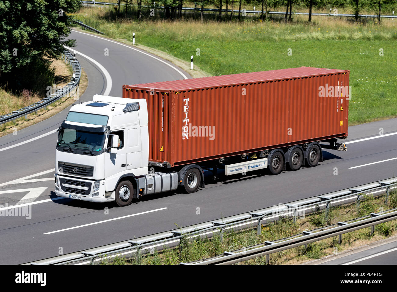 truck with Triton container on motorway. Triton International Limited