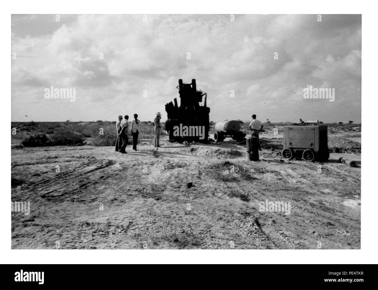 Well drilling rig seen in background of picture #28. Project put a borehole in here but the water was to saline for either human or livestock use. This hole is abandoned. The rig is secured and ready to move to a new site. Picture #29. Stock Photo