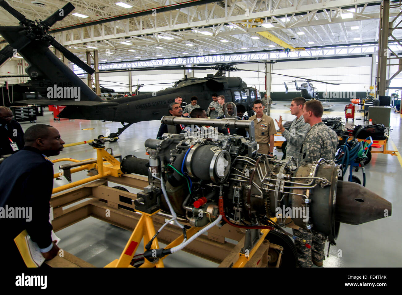 U.S. Army officers right, show a UH60 Black Hawk helicopter engine to